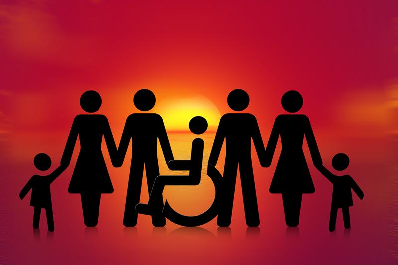 Siloettetes of parents and family including someone with a disability. The person is in a wheelchair.