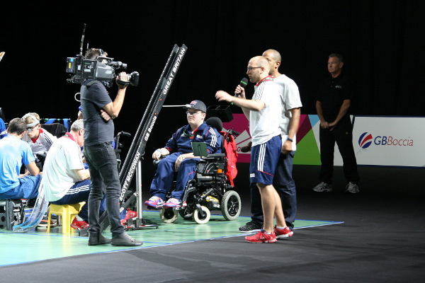 News presenter with someone in a wheelchair